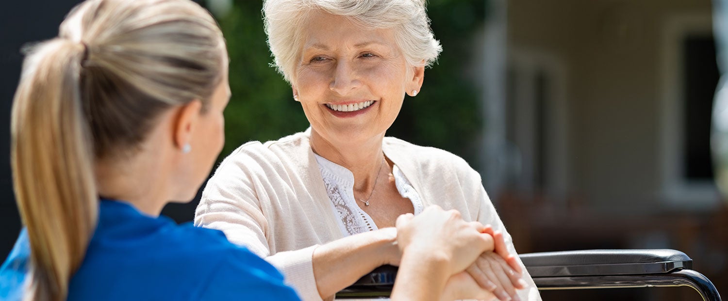 A nurse holding a patient's hand