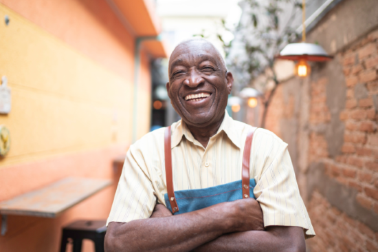 Senior male smiling at work.