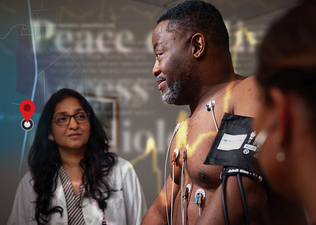 Dr. Lavanya Alapati observes a middle-aged black man with electrode patches connected to his chest for a heart stress test.