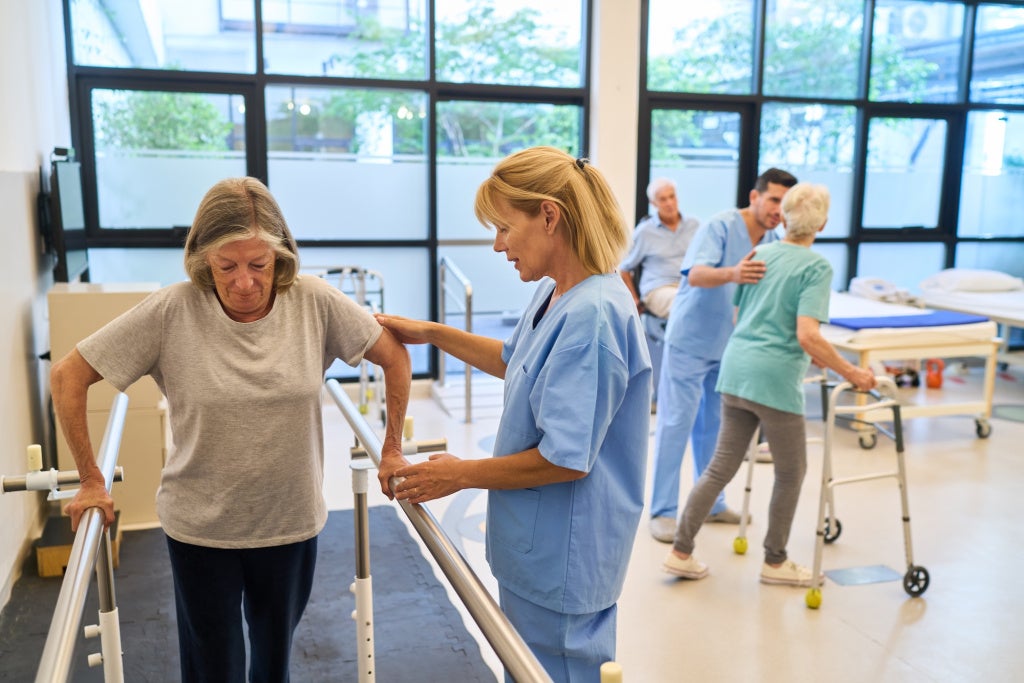 Rehabilitation therapy for seniors at a specialized care facility with staff assistance