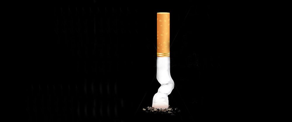 Stubbed-out-cigarette-isolated-on-black