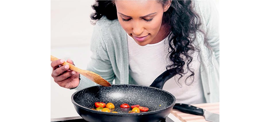 woman cooking healthy tomatoes